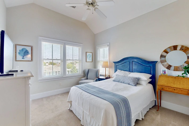 Bedroom 5 offers a king bed and direct access to a top floor deck with peekaboo water views