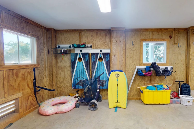 A beach wagon, corn hole set and even more beach items are found in the garage (items in photo are not guaranteed)